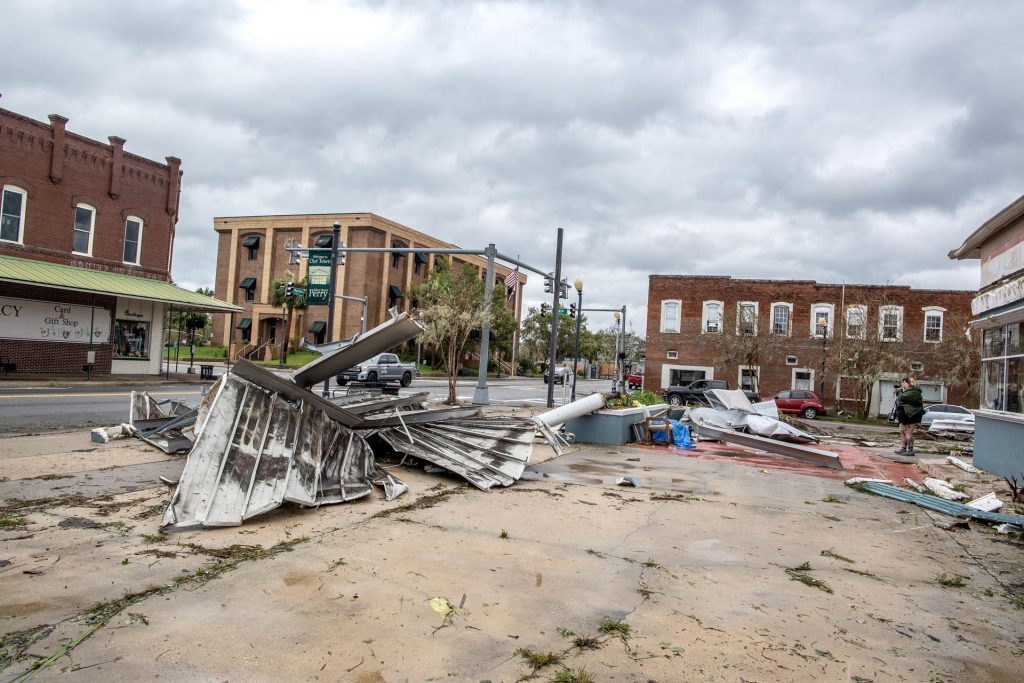 A person walks next to debris in the town of Perry, after Hurricane Idalia made landfall near Keaton Beach, Florida, USA, 30 August 2023. Hurricane Idalia makes landfall in Florida as a Category 3 storm with winds of 125 mph.
