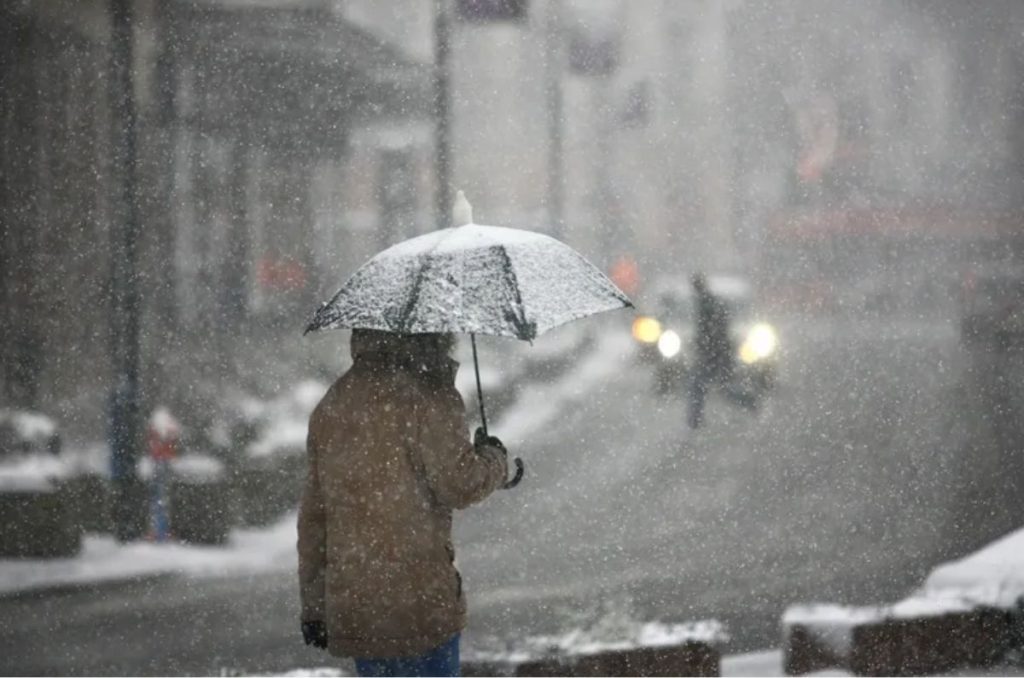 Persona caminando en una tormenta invernal