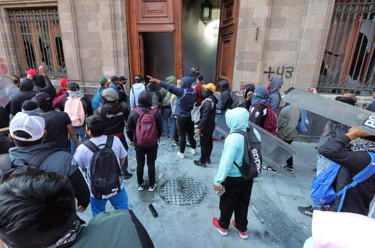 Manifestantes por Ayotzinapa derrumban puerta de Palacio Nacional